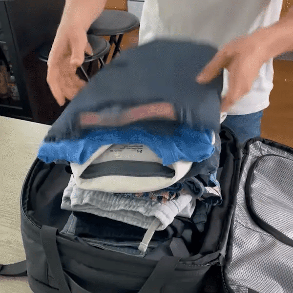Packing folded clothes into the bag