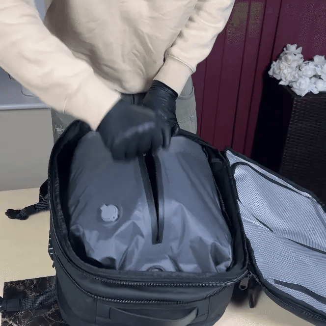 Closing the bag's long zipper before compressing